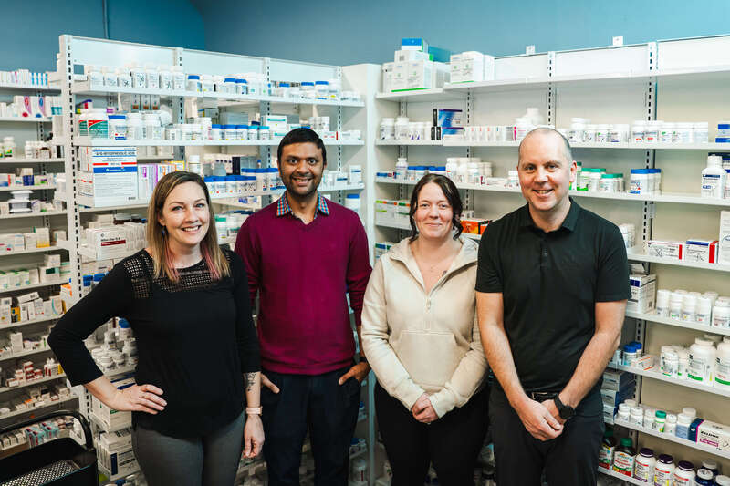 Owner Justin Pagan and staff at Budget Pharmacy